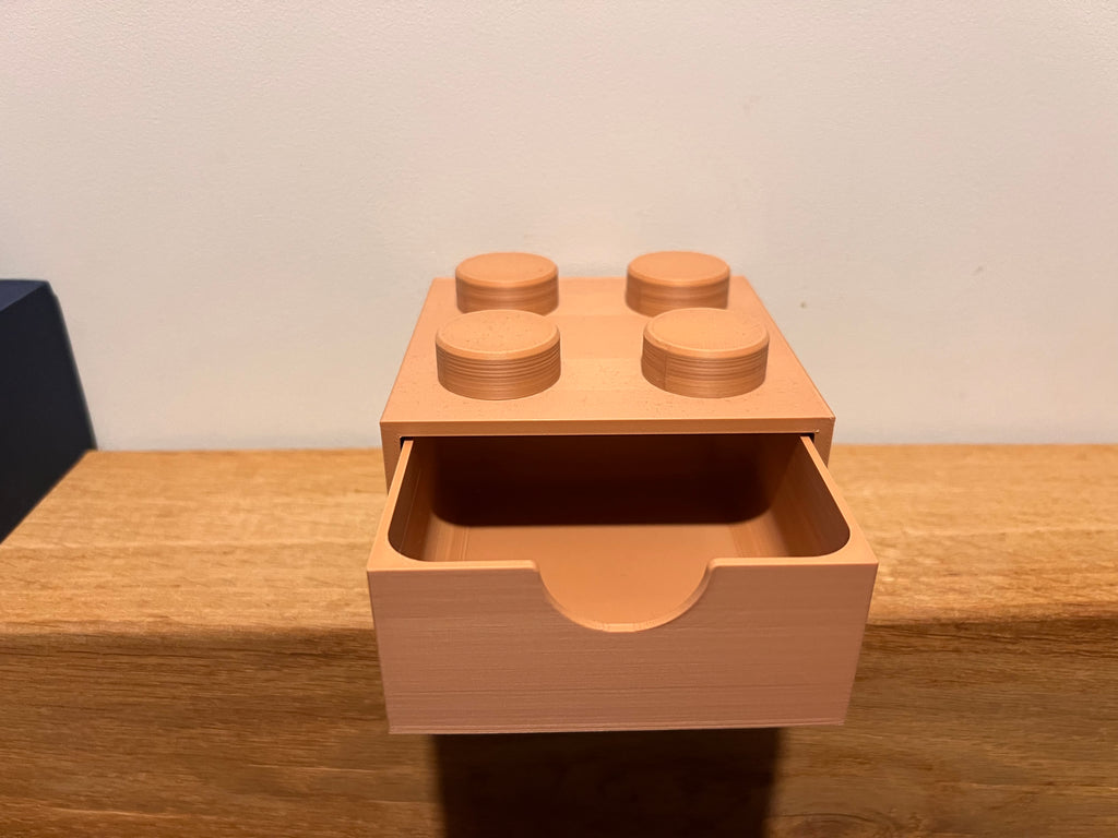 Lego-inspired 3D-printed 2×2 brick featuring a smooth sliding drawer.